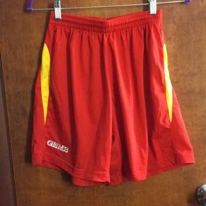 Red soccer shorts with yellow trim.